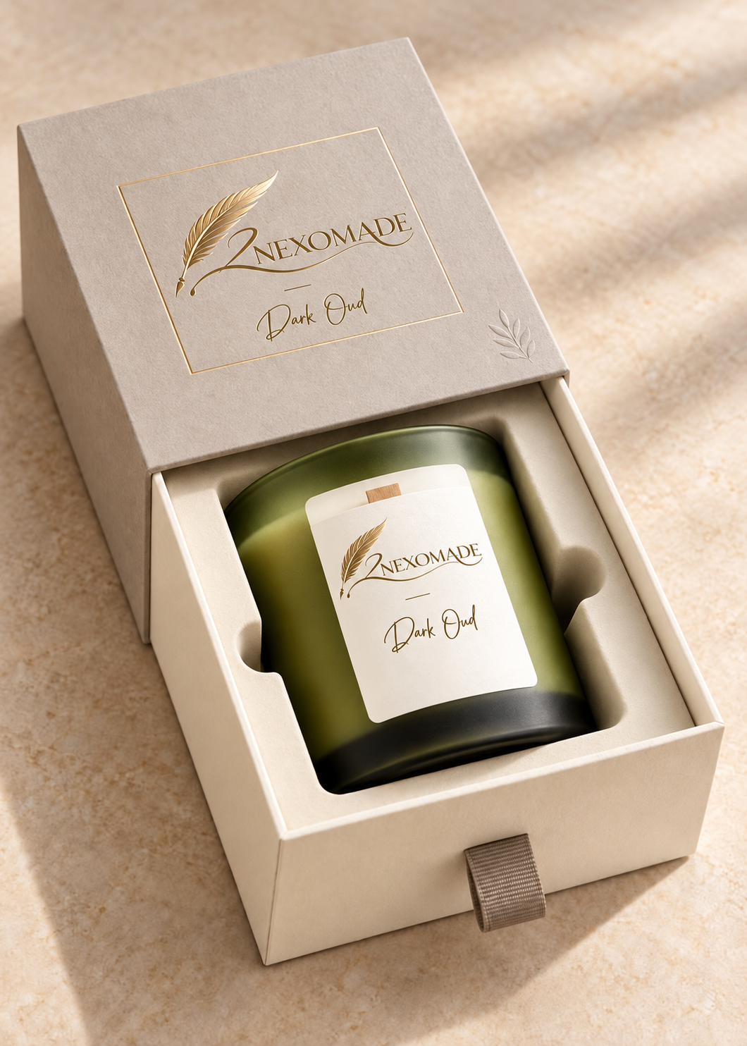 Open ivory candle gift box with a fitted insert holding one olive candle jar and gold 2NEXOMADE feather branding.
